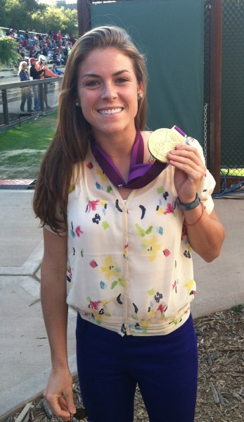 Kelley O'Hara '10 shows off her gold medal before Stanford's women's soccer home opener at Cagan Stadium on Friday. O'Hara, who was on the field for the U.S. team's entire Olympic run, was interviewed on the air as part of the Pac-12 Networks' first live broadcast. (JOSEPH BEYDA/The Stanford Daily)