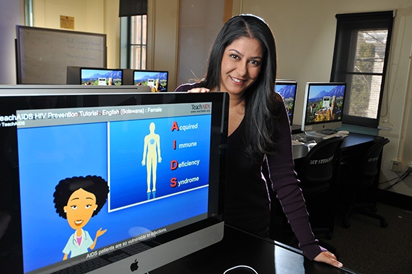 Priya Sorcar, a Stanford grad, is the founder of TeachAIDS, an organization aimed at creating animations to educate individuals across the world about AIDS. Here, she is photographed with a computer screen featuring one of the educational animations. (GLENN ASAKAWA/University of Colorado)