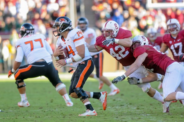 Redshirt senior linebacker Alex Debniak (42) sacked Oregon State quarterback Cody Vaz (14) on a key third-down play to help Stanford beat the Beavers and set up Saturday's showdown with No. 2 Oregon. (SIMON WARBY/The Stanford Daily)