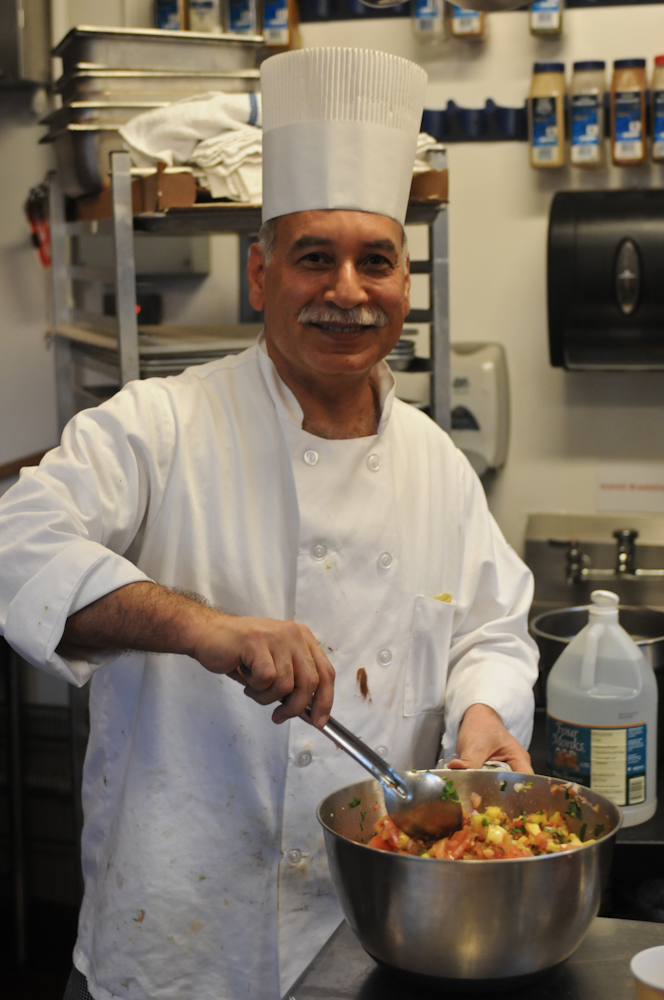 Chef Frank Hassan, shown here cooking in his beloved Bollard Eating Club, is set to lose his job at the end of this academic year. (MEHMET INONU/The Stanford Daily)