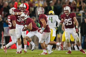 Senior wide receiver Jeff Trojan (bottom left) is congratulated by his teammates after recovering an onside kick against Oregon on Nov. 7. (DON FERIA/isiphotos.com)