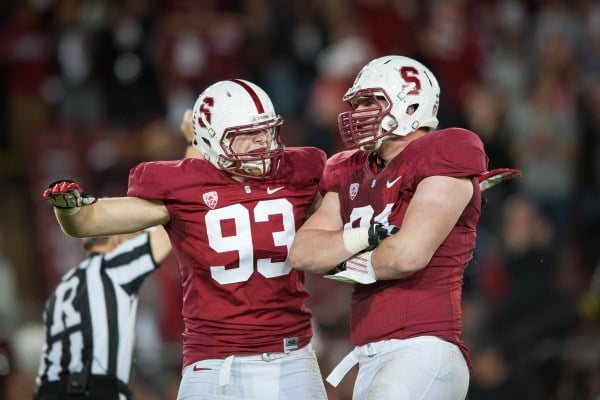 Fifth-year senior outside linebacker Trent Murphy (left) and senior defensive end Henry Anderson (right) look to bring the heat on Irish quarterback Tommy Rees tonight. (Don Feria/isiphotos.com)