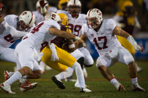 Senior inside linebacker A.J. Tarpley (right) was taken out of the Pac-12 Championship Game after he suffered a concussion. (DON FERIA/isiphotos.com)