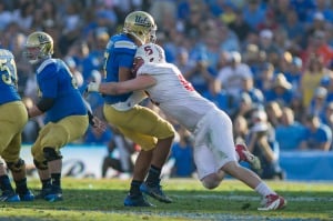 Fifth-year senior defensive end Henry Anderson (right) sacks UCLA quarterback Brett Hundley. The Cardinal defense notched five sacks and even intercepted a fake field goal pass from Hundley's backup, Jerry Neuheisel. (KAREN AMBROSE HICKEY/stanfordphoto.com)