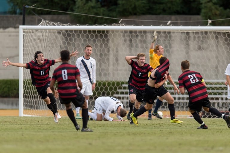 Fifth-year senior midfielder Austin Meyer (far left) and junior midfielder Ty Thompson (center) celebrate after Meyer scored the golden goal in double overtime to net the Cardinal not only a 3-2 victory in the Big Derby, but the team's first conference title since 2001. (DAVID BERNAL/isiphotos.com)