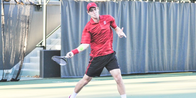 Senior John Morrissey's three-set win over USC's No. 19 Roberto Quiroz clinched Stanford's 4-3 upset victory over the No. 5 Trojans on Saturday. (RAHIM ULLAH/The Stanford Daily)