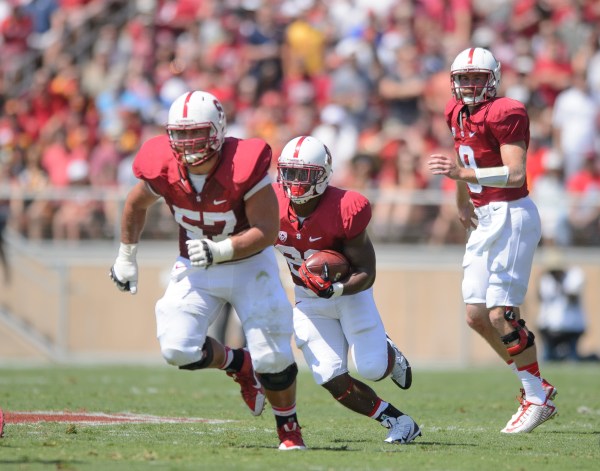 One of the keys to Stanford's game against UCLA will be whether the offensive line -- including senior right guard Johnny Caspers (left) -- can make holes for Stanford's running game. Stanford's several offensive threats on the ground -- including fifth-year senior Remound Wright (center) and sophomore Christian McCaffrey -- also have a chance to do well against a UCLA defense that has experienced several season-ending injury. (JOHN TODD/isiphotos.com)