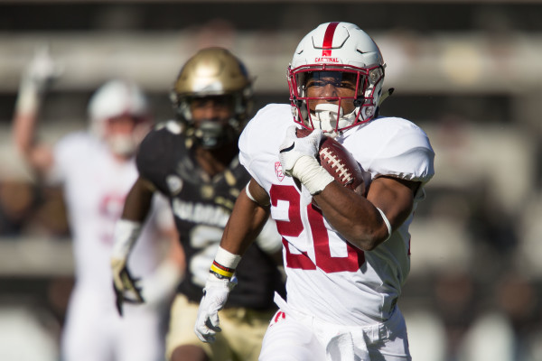 Freshman running back Bryce Love (above) breaks free from the pack for a 47-yard touchdown run in the third quarter to put Stanford up 35-10. The play came on an end-around and Love broke a tackle in the backfield before hitting the seam at full speed and outrunning everyone into the end zone. (DON FERIA/isiphotos.com)