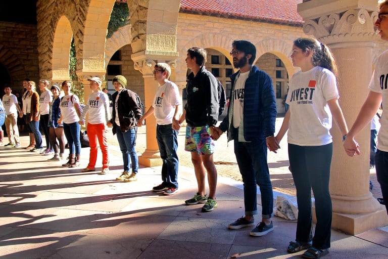 Students from Fossil Free Stanford surrounded Building 10 after being denied entry by the police officers (RAGHAV MEHROTRA/The Stanford Daily).