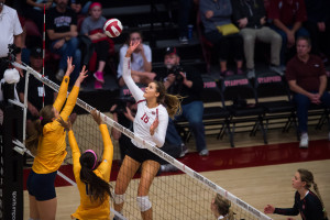 In her Senior Night celebration, outside hitter Brittany Howard (center) notched her 10th double-double of the season with 12 kills and 13 digs. (RAHIM ULLAH/The Stanford Daily)