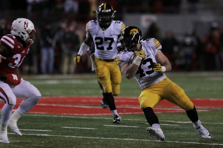 Iowa linebacker Josey Jewell (right) runs back an interception during the Iowa-Nebraska game at Memorial Stadium on Friday, Nov. 27, 2015. The Hawkeyes defeated the Cornhuskers, 28-20, to finish off a perfect regular season. (John Theulen/The Daily Iowan)