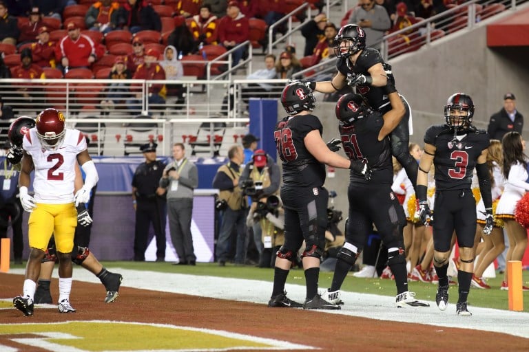 Senior guard Joshua Garnett (bottom) was named the ninth unanimous All-American in program history, while sophomore running back Christian McCaffrey (top) was named a consensus All-American for his record-breaking season. (BOB DREBIN/isiphotos.com)