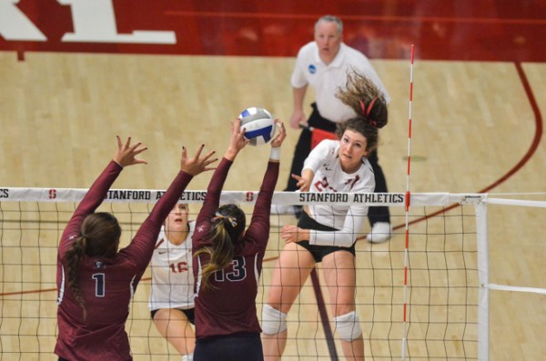 Outside hitter Jordan Burgess (right) ended her Stanford career in the Cardinal's three-set loss to Loyola Marymount in the Second Round of the NCAA Tournament. The senior hit .320 on the night and had 8 of the team's 35 kills in the match. In one of the final plays of the match, she also had an impressive hustle play to keep the ball inbounds and help Stanford win the point, which if LMU had won would have given them the match. (RAHIM ULLAH/The Stanford Daily)