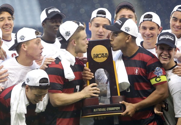 Seniors Ty Thompson (left) and Brandon Vincent (right)  kiss the trophy. Vincent was named a first-team All-American and the tournament's defensive MVP. (TONY QUINN)