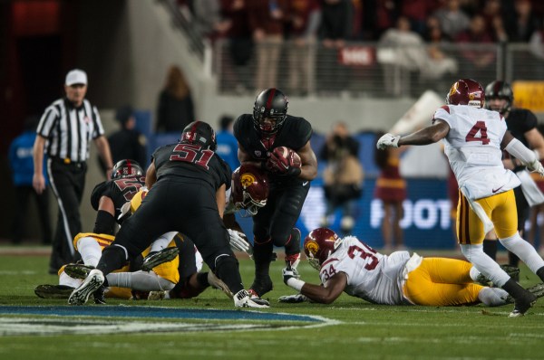 North Carolina-native Bryce Love (center) had always been far removed from the cross-country Rose Bowl,  but it began to be on his radar when he watched the 2005 National Championship, the Rose Bowl between Texas and USC. Now, as a freshman, he will be playing in the Granddaddy of Them All as one of Stanford's most promising youth. (SAM GIRVIN/The Stanford Daily)