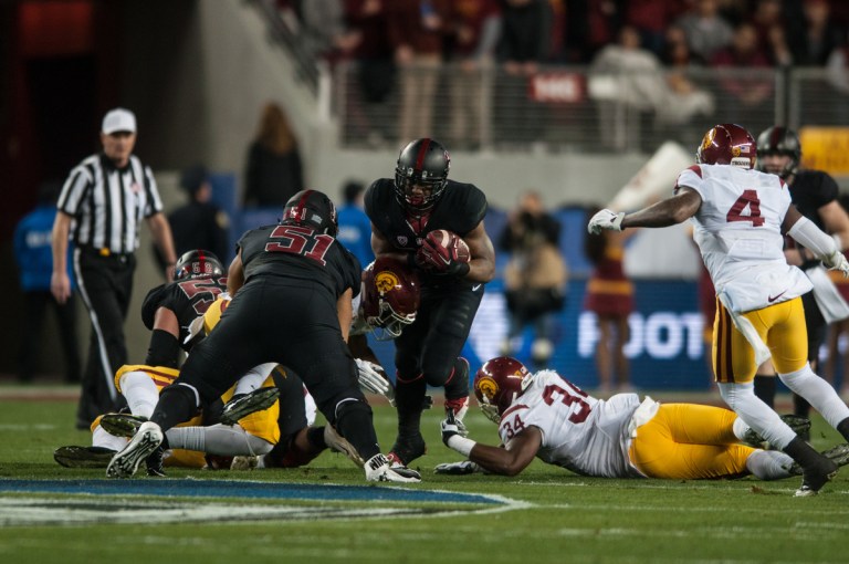 North Carolina-native Bryce Love (center) had always been far removed from the cross-country Rose Bowl,  but it began to be on his radar when he watched the 2005 National Championship, the Rose Bowl between Texas and USC. Now, as a freshman, he will be playing in the Granddaddy of Them All as one of Stanford's most promising youth. (SAM GIRVIN/The Stanford Daily)