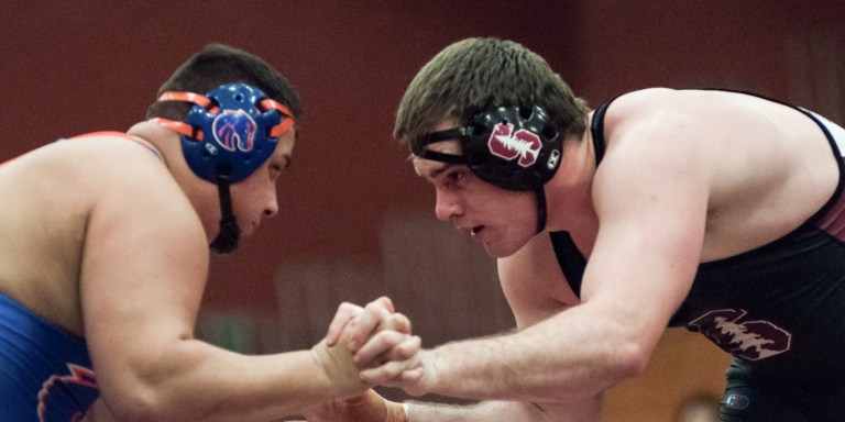 Redshirt sophomore Nathan Butler (right) pinned his opponent in 5:31 for his eighth fall of the season as part of Stanford's late push that helped it prevail over Boise State. (RAHIM ULLAH/The Stanford Daily)