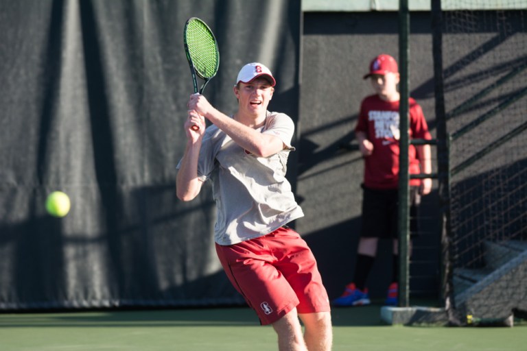 Although No. 3 Tom Fawcett (above) outdueled No. 4 Andre Goransson of Cal in a three-setter on Court 1, the Cardinal's critical loss of the doubles point was ultimately the deciding factor in the match as Stanford lost a 4-3 decision to the Golden Bears at Taube on Saturday. (RAHIM ULLAH/The Stanford Daily)