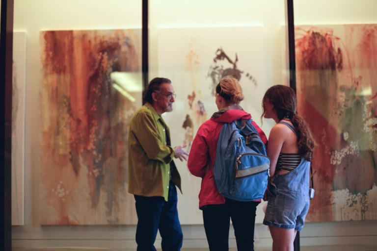 Paroginog's advisor, Enrique Chagoya, converses in front of the work. Photo by Elijah Moreau