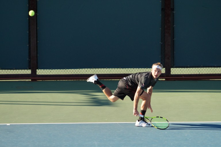 Senior Maciek Romanowicz (above) served as team captain for men's tennis this season. Romanowicz clinched the dual match victory for his third time this season, winning 6-3, 6-2 on Court 5 in Monday's sweep of USF. (LARRY GE/The Stanford Daily)