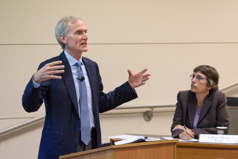 President Marc Tessier-Lavigne speaks before the Faculty Senate as senate chair Prof. Debra Satz looks on. (Courtesy of Linda Cicero)