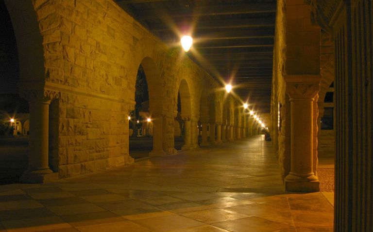 The Stanford quad, empty, on a quiet October night (Wikimedia Commons, Jonathan Gelbart).