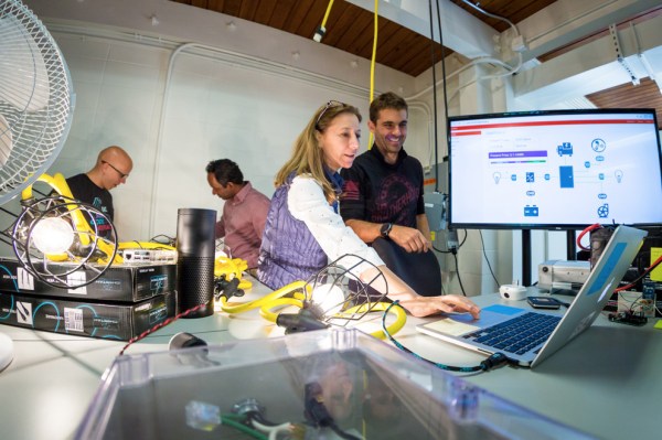 Sila Kiliccote, head of SLAC’s Gird Integration, Systems and Mobility lab, and grad student Gustavo Cezar look at a computer dashboard showing appliances in a “home hub” network. (Courtesy of SLAC)