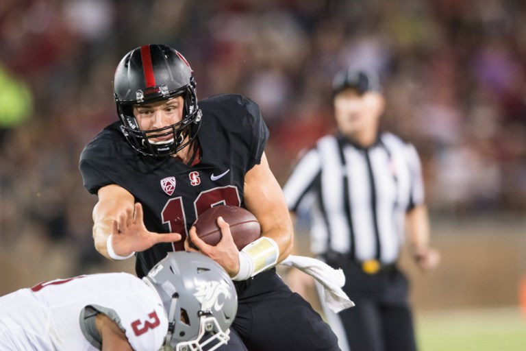 Keller Chryst keeps the ball safe as he gets ready for opposing defense. Chryst and McCaffrey have been learning to work together and renew the Stanford offense. (RAHIM ULLAH/ The Stanford Daily)