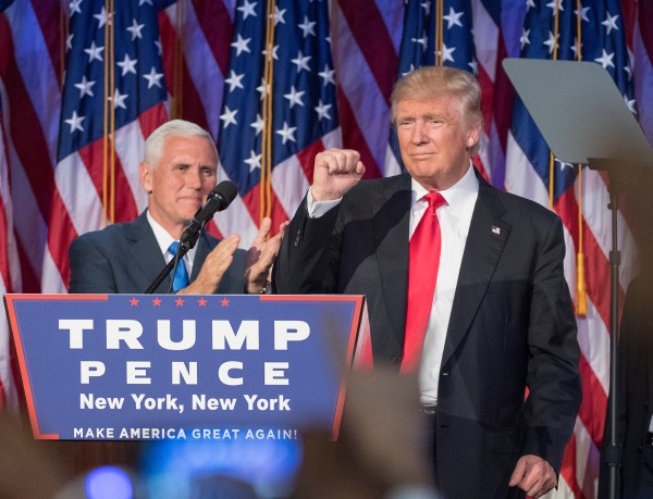 President-elect Donald Trump pumps his fist, with running mate Mike Pence standing by, following a speech to his supporters after winning the election at  the Election Night Party at the Hilton Midtown Hotel in New York City on Wednesday, Nov. 9, 2016. (J. Conrad Williams Jr./Newsday/TNS)