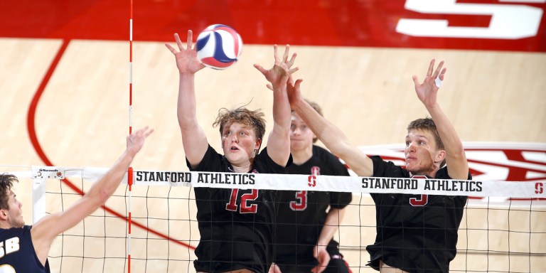 Sophomore outside hitter Jordan Ewert and freshman middle blocker Stephen Moye make a roof to block an incoming ball over the net. Moye has been a new and fruitful addition to the Cardinal lineup. (HECTOR GARCIA-MOLINA/Stanford Athletics)