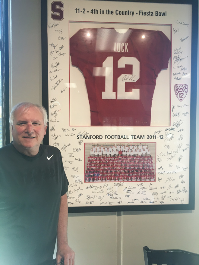 Jimmy Viglizzo stands in front of a signed Andrew Luck ‘12 jersey.