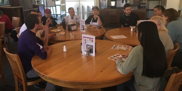 Dining workers gather with union representatives and students to discuss recent concerns over work conditions (JORDAN PAYNE/The Stanford Daily)