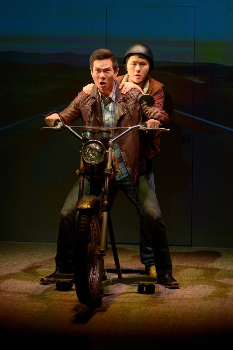 Quang (James Seol, front) and friend Nhan (Stephen Hu, back) embark on a motorcycle trip from Arkansas to California in Qui Nguyen’s Vietgone. (Courtesy of Kevin Berne)