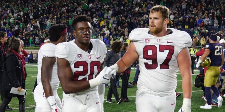 Senior linebacker Bobby Okereke (left) and senior defensive tackle Dylan Jackson (right) share a moment after a tough loss to Notre Dame. The Cardinal defense allowed 550 yards of offense.