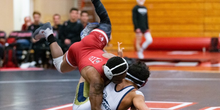 Junior Gabriel Townsell (above) provided the Cardinal with some last second heroics, vaulting his opponent overtop of his body and into a pin for a late, match clinching takedown. (JOHN P. LOZANO/isiphotos.com)