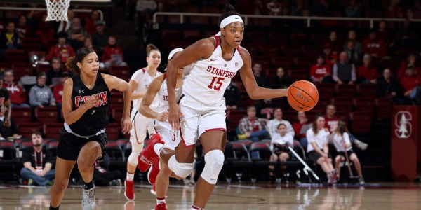 Maya Dodson (#15 above) throws up a short hook shot. The sophomore put up nine points and grabbed four rebounds for the Cardinal, and made key stops on defense throughout the game. (Hector Garcia Molina/isiphotos.com)