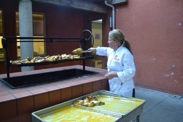 Chef transfers food into bins.