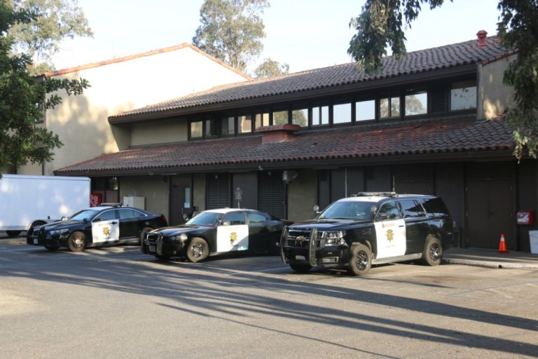 Three SUDPS police cars parked in a row.