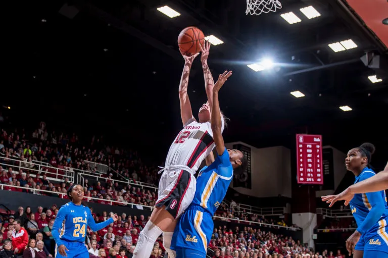 Lexie Hull jumps up for a basket over a UCLA defender.