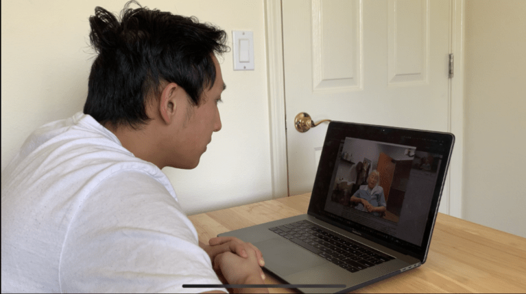 A Stanford student speaks in Cantonese with an assisted-living resident as part of an initiative to provide seniors with companionship during the pandemic. (Photo: Dan Guo).