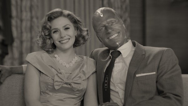 A black-and-white, vintage image of Wanda and Vision on a couch.