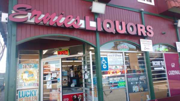 The exterior of Ernie's liquor with a notice of suspension on the window