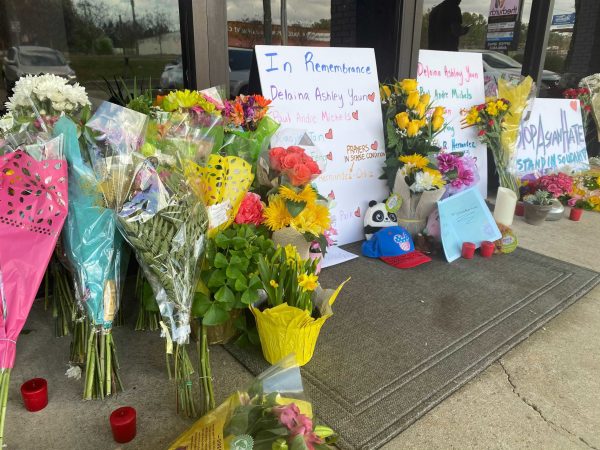 Flowers and Signs at a memorial remembering Delaina Ashley Yaun, Xiaojie Tan, Daoyou Feng, Paul Andre Michels, Hyun Jung Grant, Soon Chung Park, Suncha Kim and Yong Ae Yue.