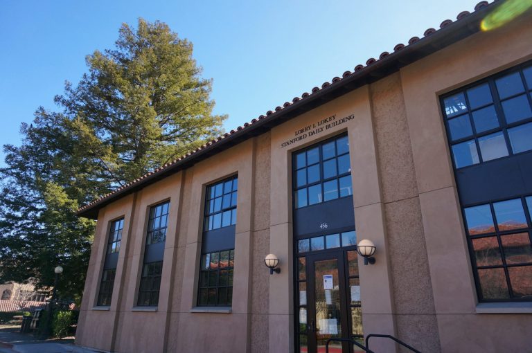 A photo of The Daily building with a blue sky.