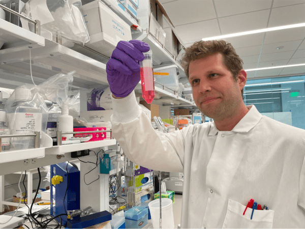 Scientist holding up test tube