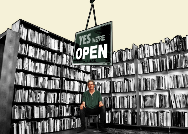 Bookstore owner sitting on a chair, surrounded by bookshelves