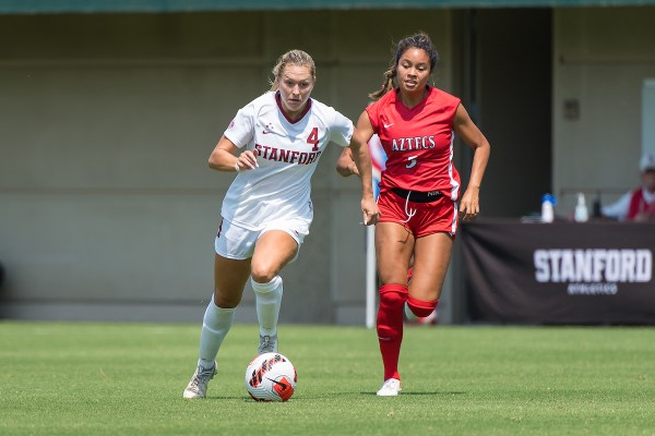 Belle Briede dribbles the ball away from a defender.