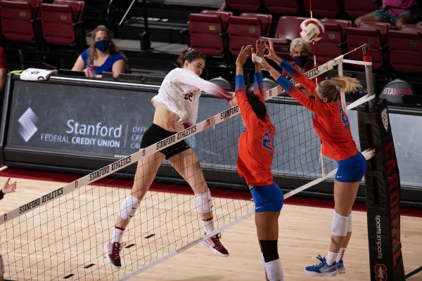 Outside hitter Caitie Baird rises above the net for a spike.