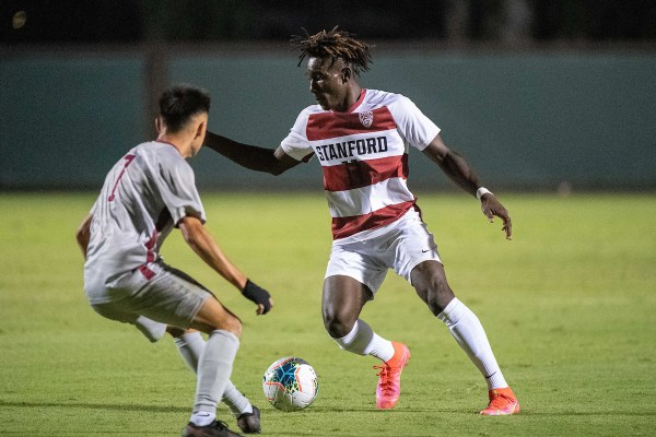 Ousseni Bouda dribbling against a defender