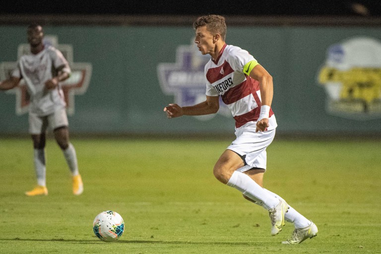 Zach Ryan dribbling the ball with a defender nearby.